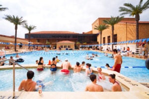 Students swimming in pool. 