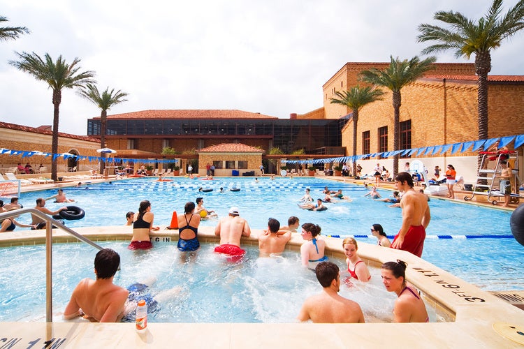 Students swim and enjoy the water at the Gregory Gym outdoor pool and aquatic complex
