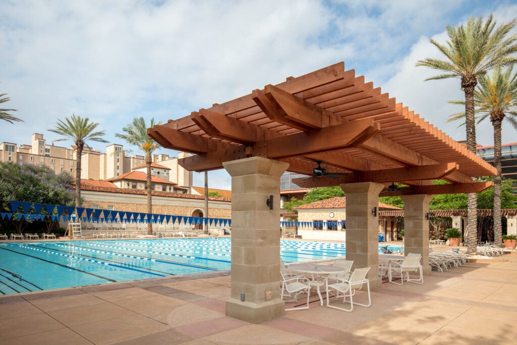gregory gym pool complex with pergola and lap pool in view