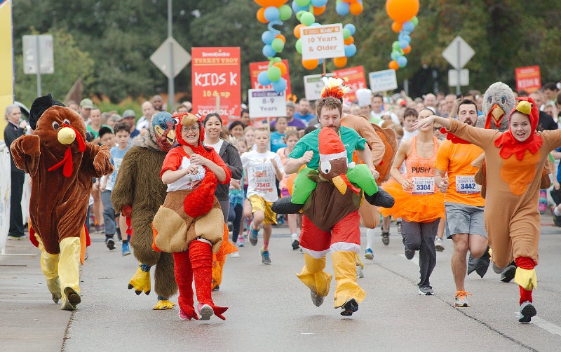 Participants enjoy the annual ThunderCloud Subs Turkey Trot Run in Turkey costumes in Austin, TX
