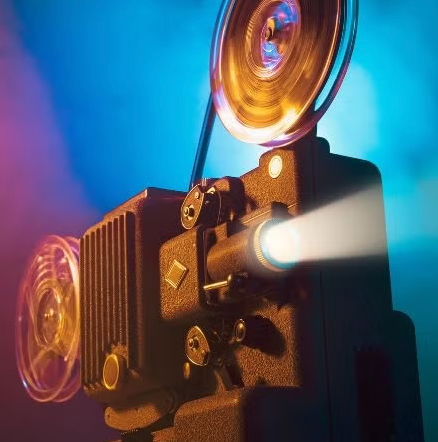 picture of an old film reel with a multi-color background