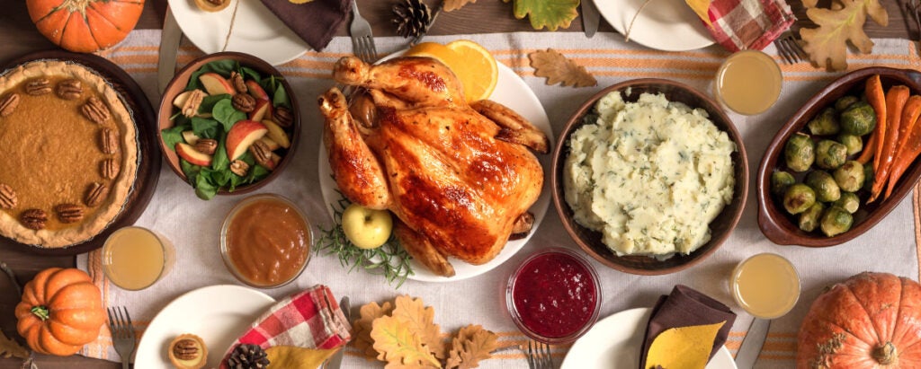 A delicious spread of Thankgiving favorite and traditional foods in the US set on a decorated table.