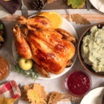 A delicious spread of Thankgiving favorite and traditional foods in the US set on a decorated table.