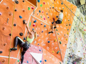 People climbing up Gregory Gym climbing wall