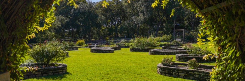 A view of the lush green grounds of the Zilker Botanical Garden, Austin, TX