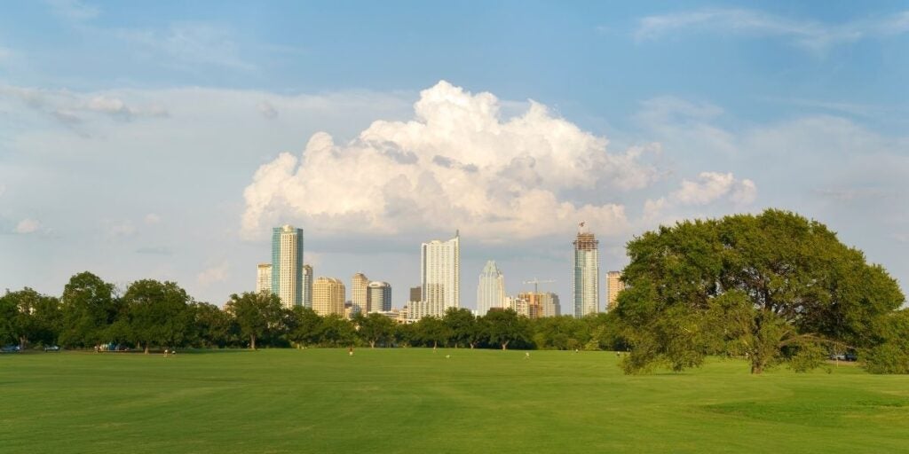 The Austin City skyline as seen from the grassy fields of Zilker Park